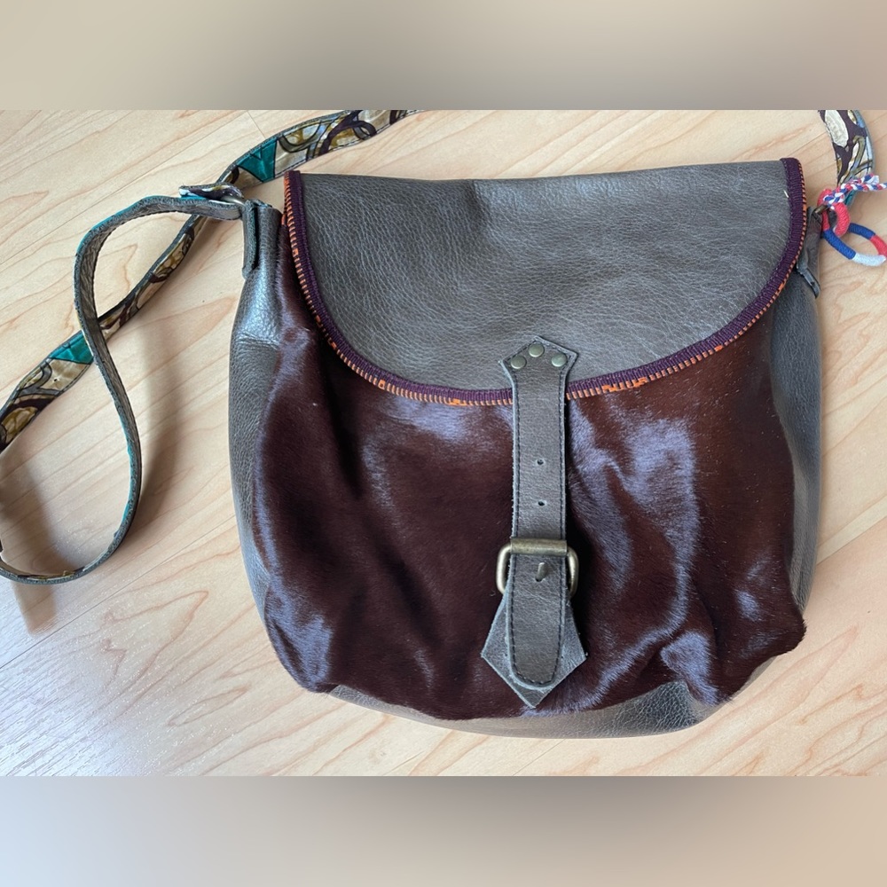Handmade genuine leather bag with animal hair panel.
